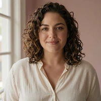 Portrait of Robyn, a warm mixed-heritage essayist in a cream linen blouse